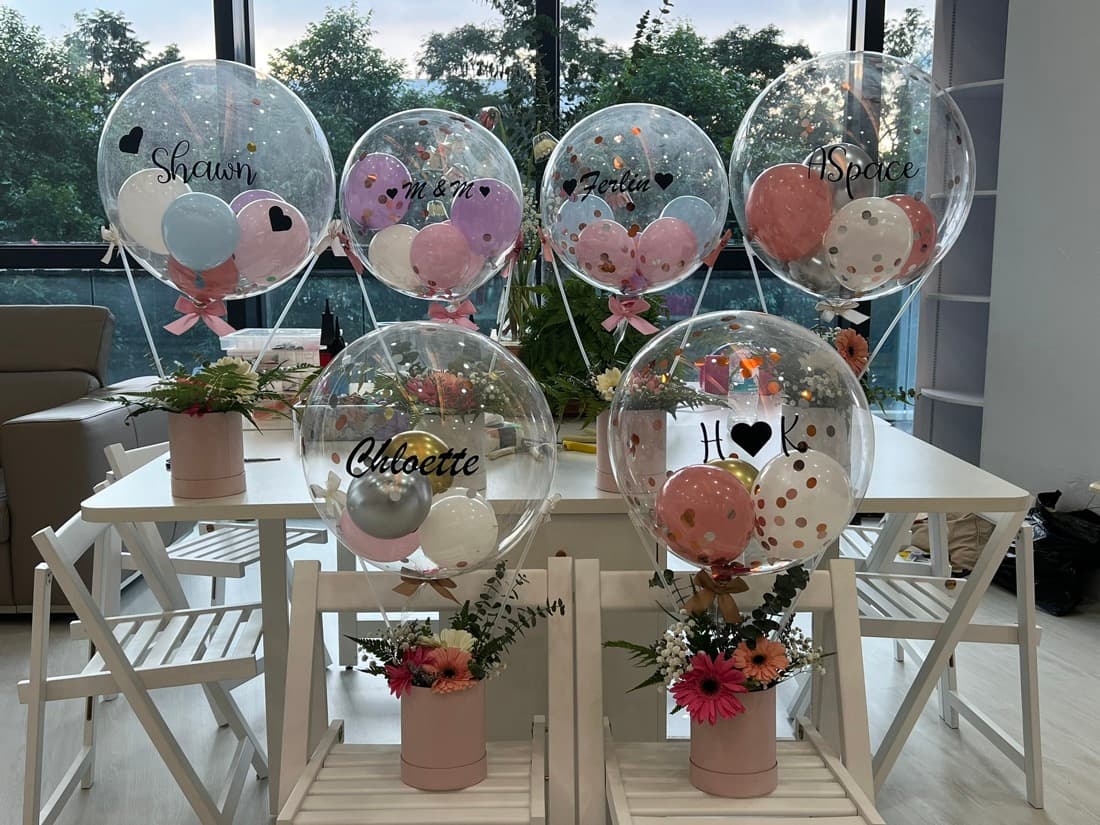 Personalised bubble balloons with floral arrangements made at an Our Second Home workshop