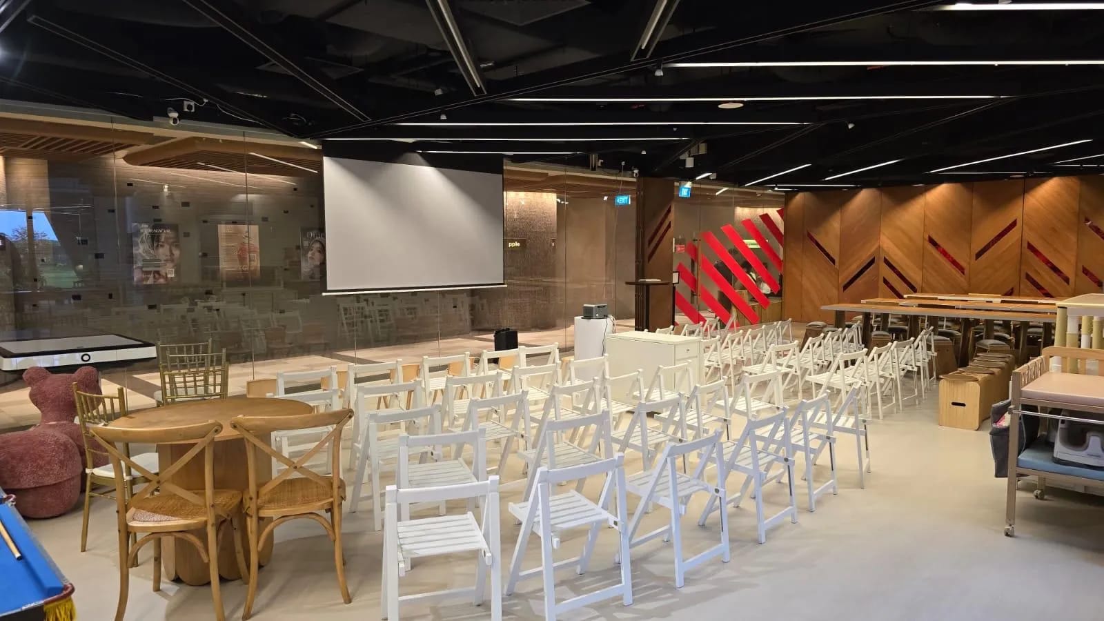 Event space set up with seating and a projector screen