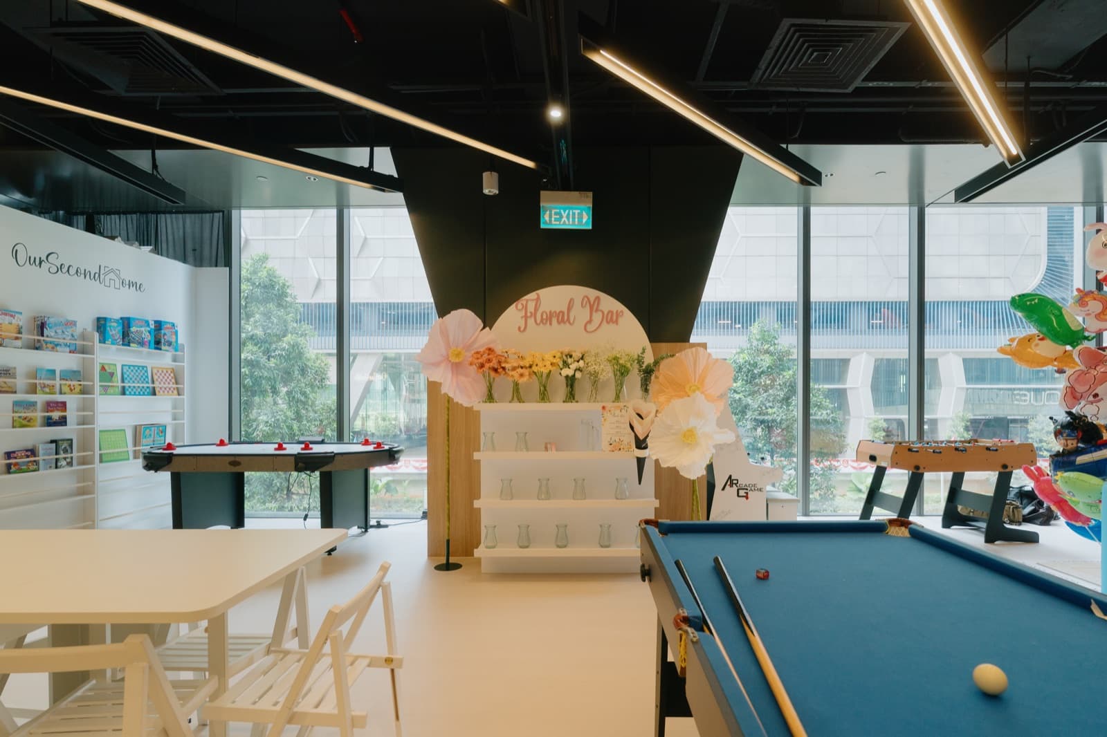 The OurSecondHome Floral Bar — a beautifully decorated venue with floral arrangements, warm lighting and intimate seating, perfect for celebrations and gatherings.